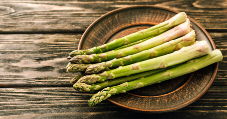 Fresh green asparagus on wooden background
