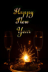 .Champagne glasses grapes and sparklers fireworks.Happy new year three-dimensional text next toChampagne grapes and sparklers fireworksChampagne grapes and sparklers fireworks