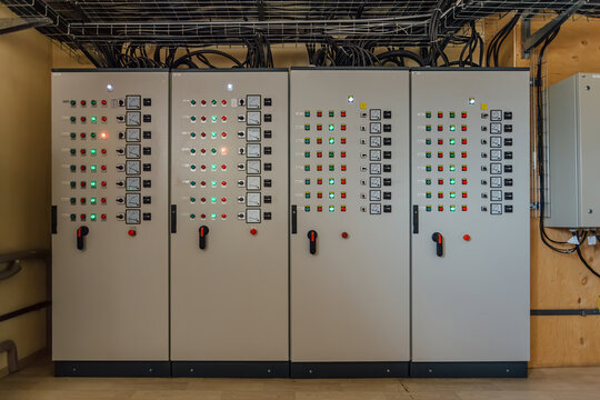 Electrical switchgear cabinets with control panels with indicator lights in factory