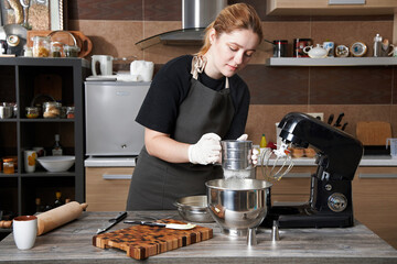 Girl pastry chef prepares desserts.