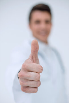 background image.a successful doctor showing thumbs up