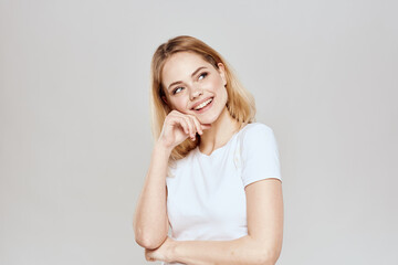 Fototapeta premium Cute blonde white t-shirt gesture with hands lifestyle light background