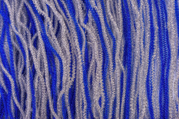 shiny Christmas swirling ribbons of blue and silver rain. view from above