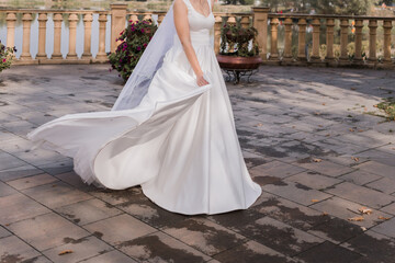 Fototapeta na wymiar the bride on the embankment in a wedding dress
