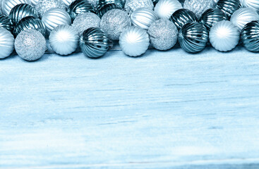 New Year Balls on blue wood background. Christmas background with colorful baubles. Happy New Year greeting card