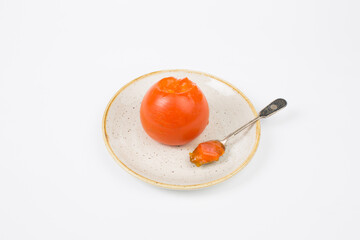 Persimmon fruit eating by spoon