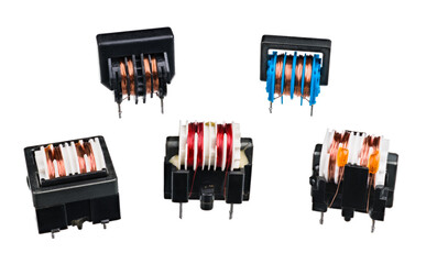 Group of various transformers with coils and black core isolated on white background. Passive electronic devices for electrical energy transfer between two circuits. Set of electrotechnic components.
