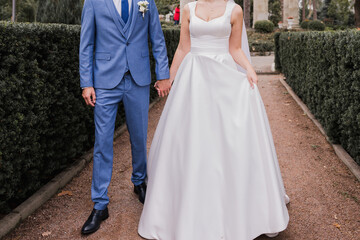 Naklejka na ściany i meble groom with bride together autumn park at wedding
