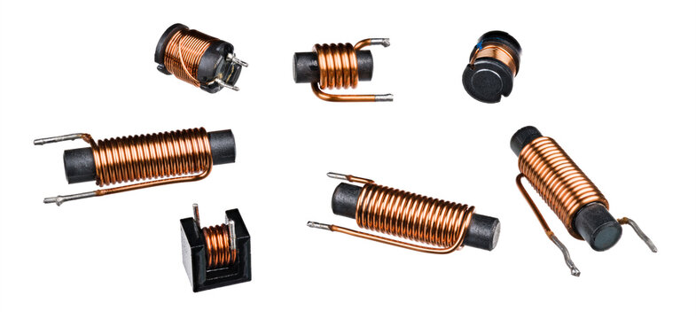Set of solenoid coils with black ferrite core isolated on white background. Close-up of cylindric inductors with helical copper wire winding. Group of electronic components. Electromagnetic induction.