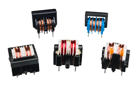 Group Of Various Transformers With Coils And Black Core Isolated On White Background. Passive Electronic Devices For Electrical Energy Transfer Between Two Circuits. Set Of Electrotechnic Components.