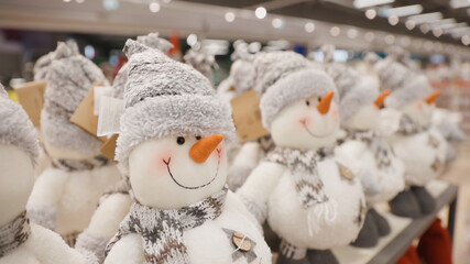 Many white Snowman toys for decorations displayed in shop