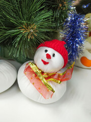 Handmade of felt snowman hanging on a Christmas tree