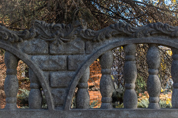 A stone fence decorated with sculpted pillars