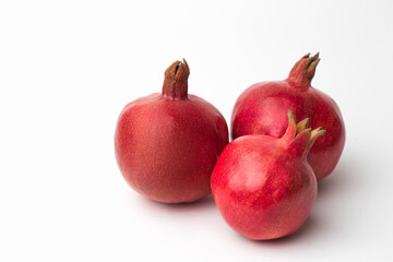 Whole pomegranate in studio on white background