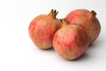 Whole pomegranate in studio on white background