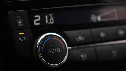 automatic air conditioner in the car. Air conditioner ring. Display indicates temperature inside the car. Cooling air in the car