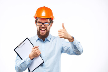 A man in orange paint in glasses documents a manual industry