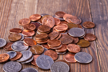 American coins and US dollars on a wooden table