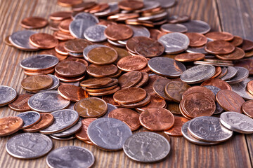 American coins and US dollars on a wooden table