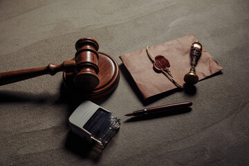 Notary seal, wooden gavel, notarized document on a table. Legality concept.