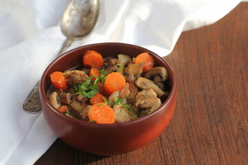 Meat stew with vegetable on rustic wooden background