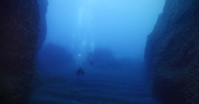 scuba divers enjoying the topography and fauna underwater ocean scenery mediterranean sea 