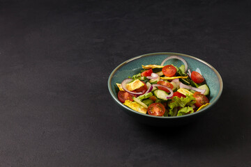 Traditional Arabic fattoush salad on a plate on a gray background.