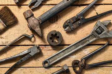 Old vintage household hand tools still life on a wooden background in a DIY and repair concept