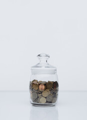 Fototapeta na wymiar Coins in a glass bank. Deposit concept.