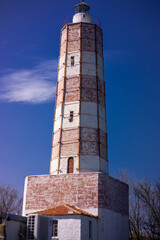 Big Lighthouse isolated on clear blue sky and one cloud