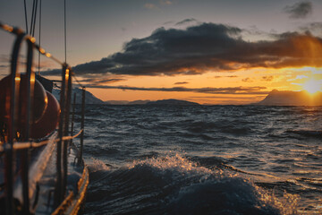 View from northen yacht sailing through sunset sea at Norway winter water