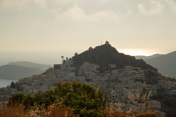View at Ios main village or Chora at sunset time from a viewpoint in the mountain above, Ios island, Greece