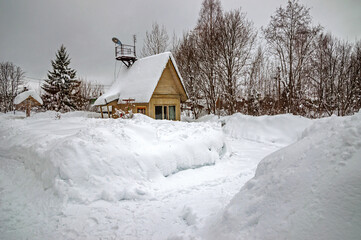 Real, Russian winter, when frost and a lot of snow, in the country village, with small houses, roads through high snowdrifts