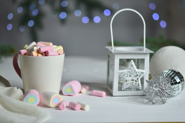 Marshmallow, lantern and Christmas balls on bokeh background.