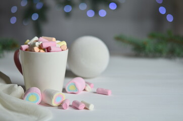 Marshmallows and Christmas balls on the left, against a bokeh background.