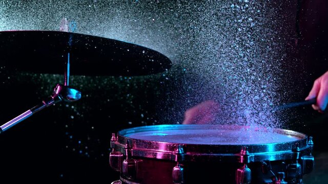 Super Slow Motion Shot of Drum Hit and Splashing Water at 1000 fps.
