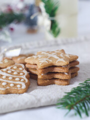 Close up of homemade Christmas biscuits decorated with frosted icing with blurry background 