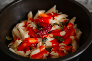 White macaroni with tomato, chilli, oregano, cheese and spices