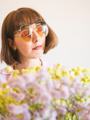 Young woman in pink shirt wearing two color sunglasses. Fashion accessories concept