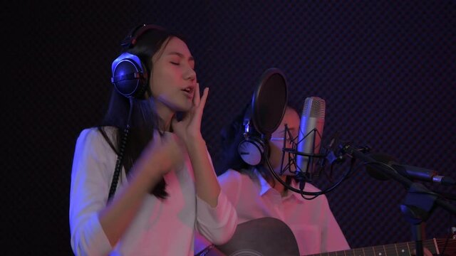Audio recording concept. Young artist duo singing in the studio. 4k Resolution.