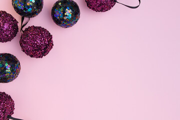 flat lay with christmas balls on pink