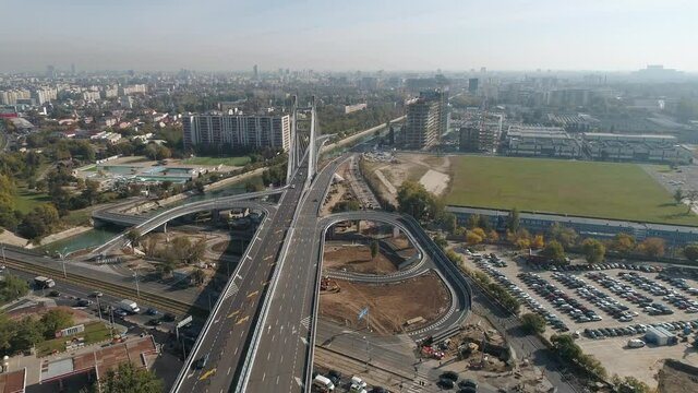 Aerial footage of a suspended bridge in Bucharest on a sunny day
