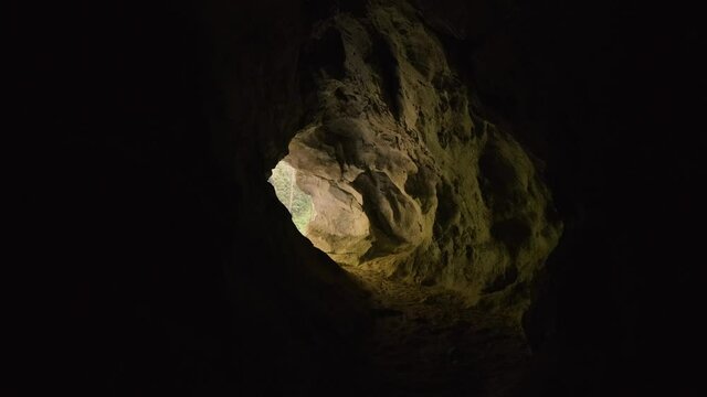 Inside Cave Following Path. Finding Way Out of the Stony/Sandy Cave, Revealing Outside Natural Light. Rakov &Scaron;kocjan, Slovenia.