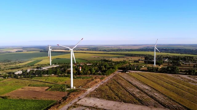 Aerial drone shot of three wind turbines located on a field near Donduseni in Moldova