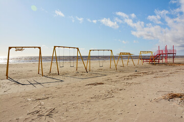 Empty swings on the beach in Pärnu, Estonia.