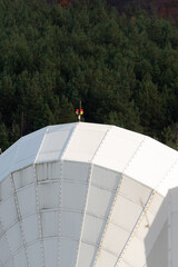 Solar radio telescope hidden in forest nature surveillance spy technology mobile antenna beautiful sunny autumn day