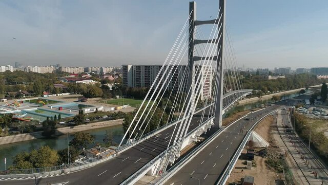 Aerial footage of a suspended bridge in Bucharest on a sunny day