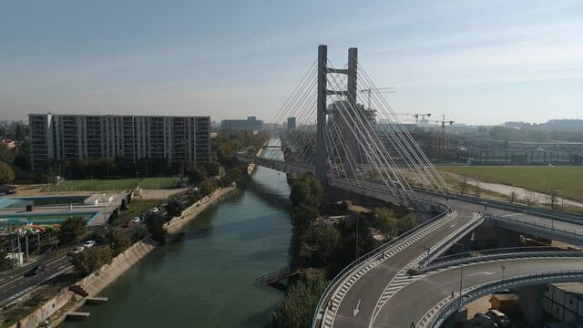 Aerial footage of a suspended bridge in Bucharest on a sunny day