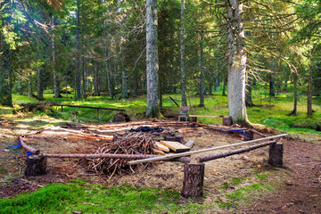 Camping spot with bonefire place in a forest