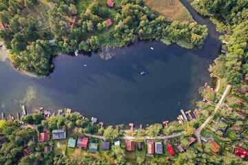 Drone view of summer cottages over Narie lake of Ilawa Lake District in Kretowiny, small village in Warmia Mazury region of Poland